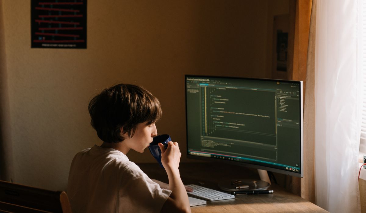 A compact, nimble device running alongside a towering server rack, both glowing